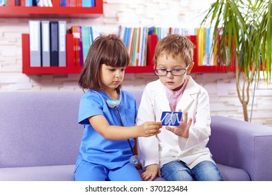 cute kids playing doctors in office