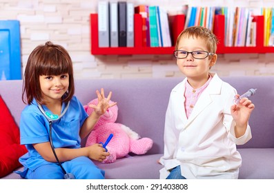 cute kids playing in doctors with toy instruments