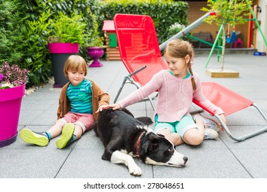 Cute Kids Playing With A Dog On A Backyard