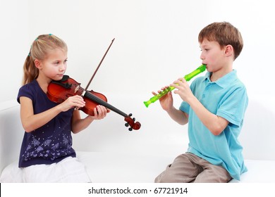 Cute kids playing flute and violin together