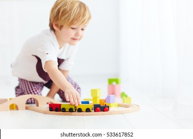 Cute Kids Playing With Toy Railway Road At Home. Focus On Train