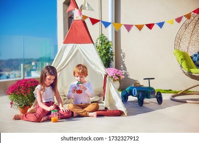 Cute Kids Playing Toys On Summer Patio, Drinking Fresh Lemonade