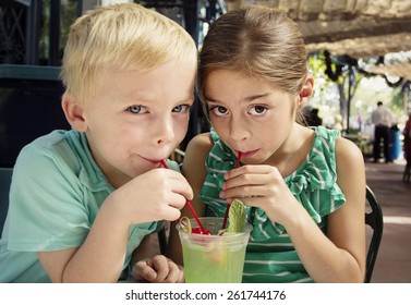 Cute Kids Sharing A Mint Julep Drink At A Cafe