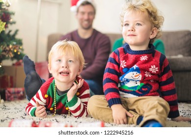 Cute Kids Watching Tv With Their Parents, Wearing Christmas Clothes