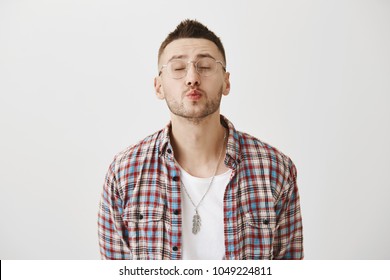 Cute Kisser Wants Some Love. Portrait Of Good-looking Mature Bearded Male In Trendy Outfit Closing Eyes And Waiting For Kiss With Puckered Lips, Standing Over Gray Background. Man Dreaming About Girl