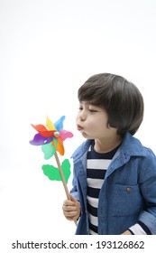 Cute Korean Kid Playing With Pinwheel