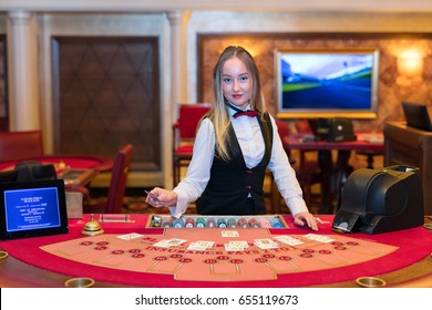 Cute Lady Casino Dealer At Black Jack Table.