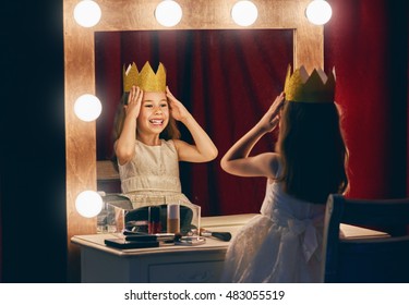Cute little actress. Child girl in Princess costume on the background of theatrical scenes and mirrors. - Shutterstock ID 483055519