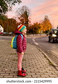 Cute little adorable toddler girl on her first day going to playschool. Healthy happy baby walking to nursery school. child with backpack going to day care on the city street, outdoors