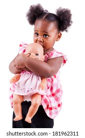 little girl holding doll