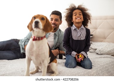 Cute little african american girl playing with her dog. - Powered by Shutterstock