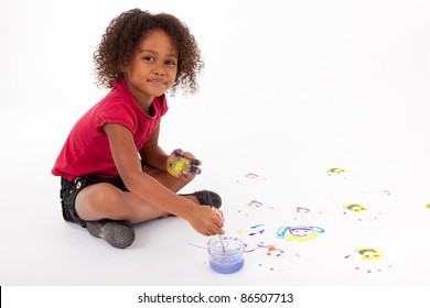 Cute Little African American Girl Painting On The Floor