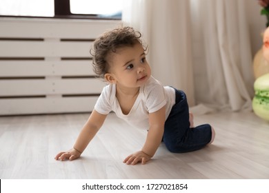 Cute Little African American Toddler Infant Go On Hands And Knees Learn To Walk On Floor At Home, Small Biracial Baby Girl Child Creep On Fours, Make First Steps Play Indoor, Childcare Concept