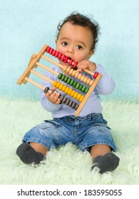 Cute little African baby boy playing with an abacus
