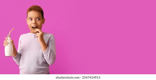 Cute little African-American boy eating cookie with milk on purple background with space for text - Powered by Shutterstock