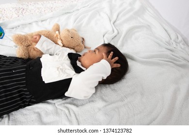 Cute Little Asain Baby Boy Lying On Soft Towel And Play Toy