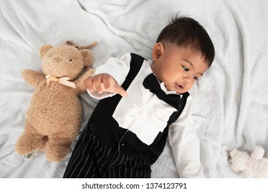 Cute Little Asain Baby Boy Lying On Soft Towel And Play Toy