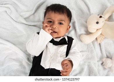 Cute Little Asain Baby Boy Lying On Soft Towel And Play Toy