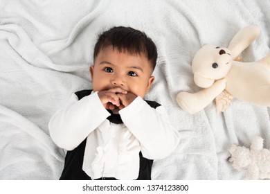 Cute Little Asain Baby Boy Lying On Soft Towel And Play Toy