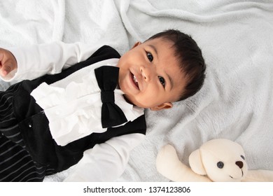 Cute Little Asain Baby Boy Lying On Soft Towel And Play Toy