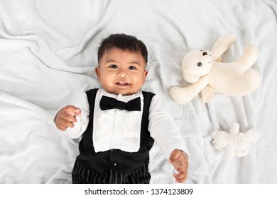 Cute Little Asain Baby Boy Lying On Soft Towel And Play Toy