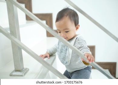 Cute Little Asian 10 Months Old Toddler Baby Girl Child Climbing Up Stairs At Home Alone, Movement, Balance & Coordination, Stair Climbing Developmental Milestone Concept