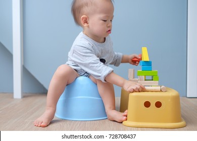 Cute Little Asian 18 Months Old / 1 Year Old Toddler Baby Boy Child Sitting On Potty Playing With Wooden Blocks Toy. Kid Playing With Educational Toy & Toilet Training Concept. - Selective Focus