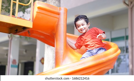 Cute Little Asian 2 Year Old Toddler Baby Boy Child Playing On A Slide At Indoor Playground In Department Store, Baby Sliding Down Slide, Kid First Experience Concept.