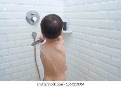 Cute Little Asian 3 - 4 Years Old Toddler Boy Child Take A Shower By Himself, Kid Playing With Shower, Encourage Self-Help Skills In Children, The Growth Of Independence In Young Child Concept