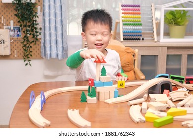 Cute Little Asian 5 Years Old Boy Child Having Fun Playing With Wooden Train, Railway And Building Block Toys Indoor At Home, Educational Toys For Young Children, Photo In Real Life Interior