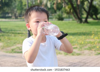 Cute Little Asian 5 Years Old Boy Child Drinking Pure Water From Reusable Water Bottle On Nature In The Park, Kid Drink Water After Exercise, Zero Waste Concept, Soft And Selective Focus