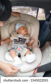 Cute Little Asian Baby Boy Sitting On Carseat, For Safety