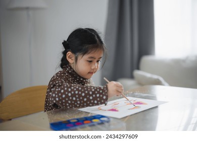 Cute little asian baby smiling painting with colorful paints using watercolor. Asian girl using paintbrush drawing color. Baby activity lifestyle concept. - Powered by Shutterstock