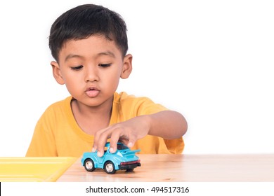 child playing with cars