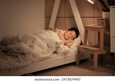 Cute little Asian boy sleeping in bed - Powered by Shutterstock