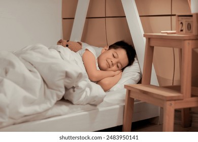 Cute little Asian boy sleeping in bed - Powered by Shutterstock