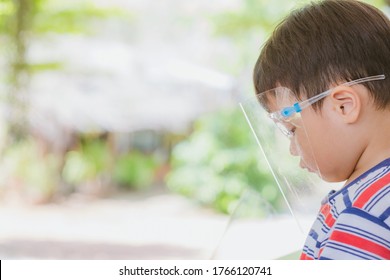 Cute Little Asian Boy Wear Face Mask And Sheild As Protection During The Covid 19 Virus Outbreak. Copy Space.