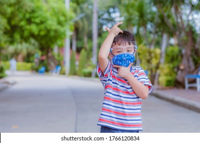 Cute Little Asian Boy Wear Face Mask And Sheild As Protection During The Covid 19 Virus Outbreak. Copy Space.