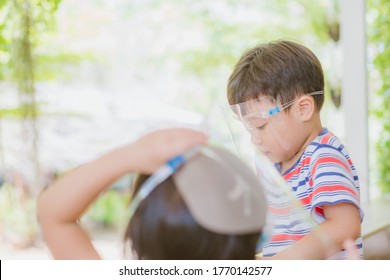 Cute Little Asian Boy Wear Face Mask And Sheild As Protection During The Covid 19 Virus Outbreak. Copy Space.