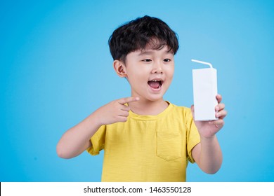Cute Little Asian Child Boy Hold Milk Box And Drink On White Background Isolated