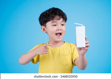 Cute Little Asian Child Boy Hold Milk Box And Drink On White Background Isolated