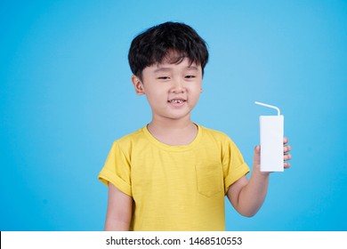 Cute Little Asian Child Boy Hold Milk Box And Drink On White Background Isolated