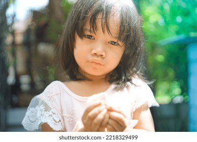 Cute Little Asian Girl Holding A White Bouquet. Child Planting Spring Flowers. 