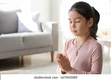 Cute Little Asian Girl Praying At Home