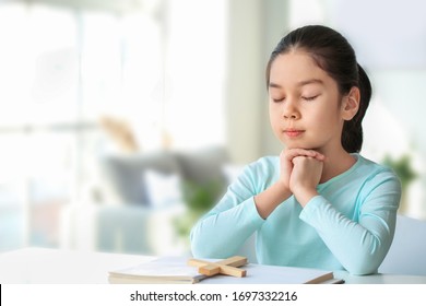 Cute Little Asian Girl Praying At Home