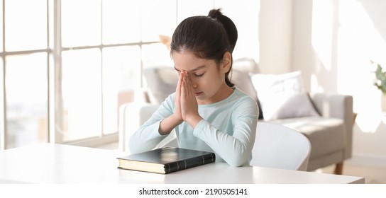 Cute Little Asian Girl Praying At Home