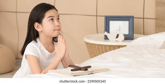 Cute Little Asian Girl Praying At Home