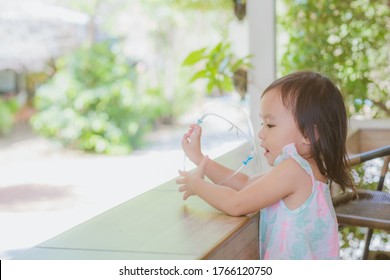 Cute Little Asian Girl Wear Face Mask And Sheild As Protection During The Covid 19 Virus Outbreak. Copy Space.