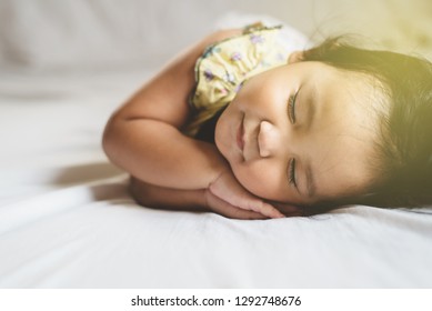 Cute Little Asian Toddler Sleeping On Her Bed. Concept Of Childhood And Sleep