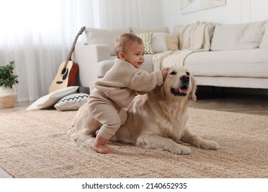 Cute Little Baby With Adorable Dog On Floor At Home